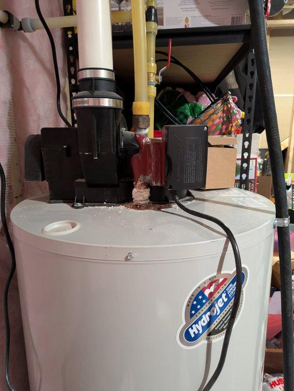 Responded to a water heater recirculation pump leak on a Hydropro tanked water heater system. Upon inspection, discovered extensive corrosion and mineral deposits around the pump connections and mounting base, indicating a prolonged slow leak that had compromised the unit's integrity. Assessed the circulation pump assembly and associated piping connections, documented the corrosion damage with photographs, and ordered the appropriate replacement recirculation pump to restore proper system operation and eliminate the leak.