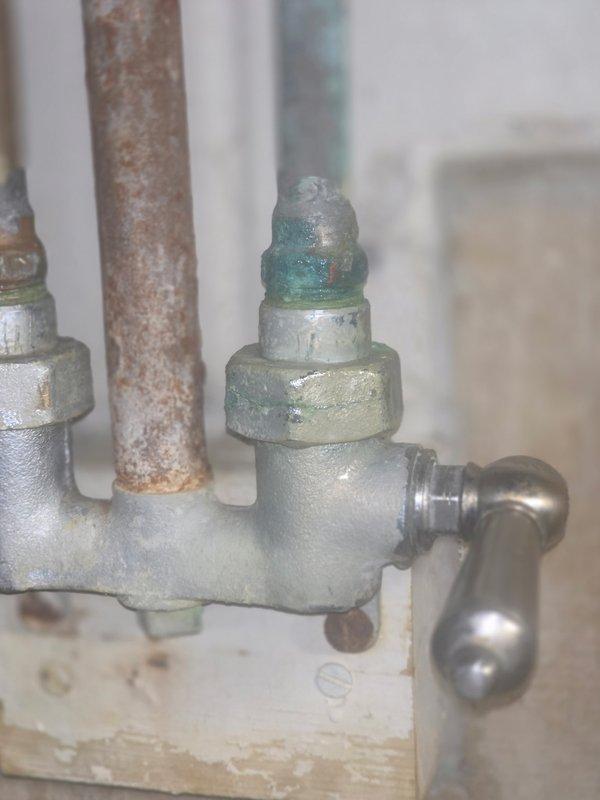 Responded to downstairs shower with continuous drip caused by stripped hot and cold valve handles that could not be turned off completely. Upon inspection, found severely corroded cartridges with visible verdigris formation on valve assemblies and deteriorated internal components preventing proper shutoff. Replaced both hot and cold cartridges to restore full operational control and eliminate leak.