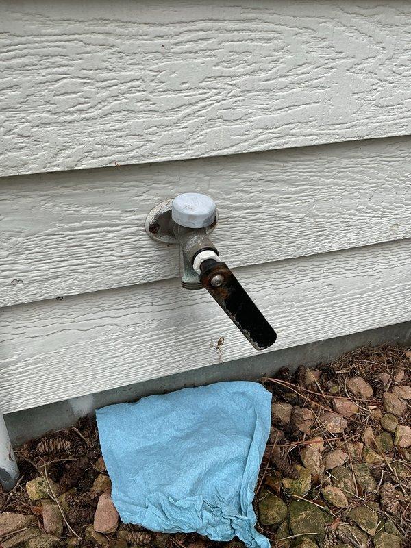 Responded to a continuously running front exterior hose bib that was leaking despite the homeowner's previous attempt to replace a bushing. Upon diagnostic inspection, removed the valve stem and identified a severely damaged rear seal as the source of the leak. Utilizing a seal kit provided by the customer, installed a new valve stem assembly and complete seal kit to restore proper function. Tested the hose bib for approximately 10 minutes following installation to verify complete leak cessation and proper operation. The spigot showed visible exterior corrosion and weathering consistent with extended outdoor exposure, but the internal repair successfully resolved the continuous water flow issue.
