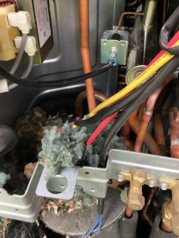 Replaced wiring harness on heat pump unit under parts and labor warranty. Returned to site to replace temperature sensors damaged by rodent activity; one sensor remains on order for future installation. Diagnosed zone system malfunction and determined that three zone damper motors have failed and require replacement rather than the initially suspected zone board. Temporarily configured system by locking main level and second floor zones open while closing basement damper to maintain operation until damper motors can be replaced. Parts have been ordered for zone system repair completion.