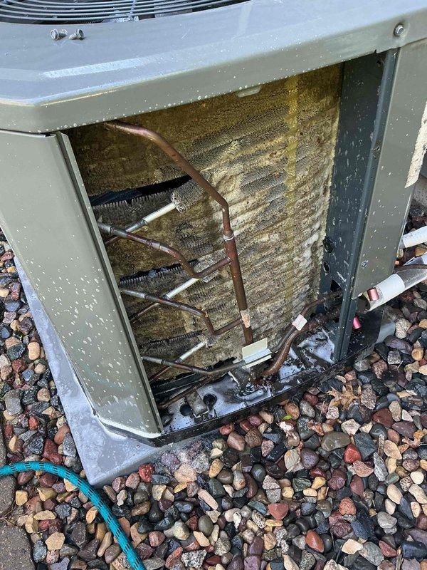 Responded to no cooling complaint on 6-year-old central air conditioning system that was attempting to start but shutting down after approximately two seconds of operation. Upon inspection, diagnosed failed capacitor preventing compressor from maintaining operation and severely plugged condenser coil restricting airflow and heat transfer. Replaced defective capacitor with proper replacement unit, installed hard start kit to assist compressor during startup cycles and reduce stress on electrical components, and performed thorough chemical coil cleaning to remove heavy accumulation of dirt, dust, and debris from condenser coil fins. System tested after repairs, confirmed proper startup sequence, verified adequate amperage draw on compressor, and validated cooling operation restored to normal parameters.