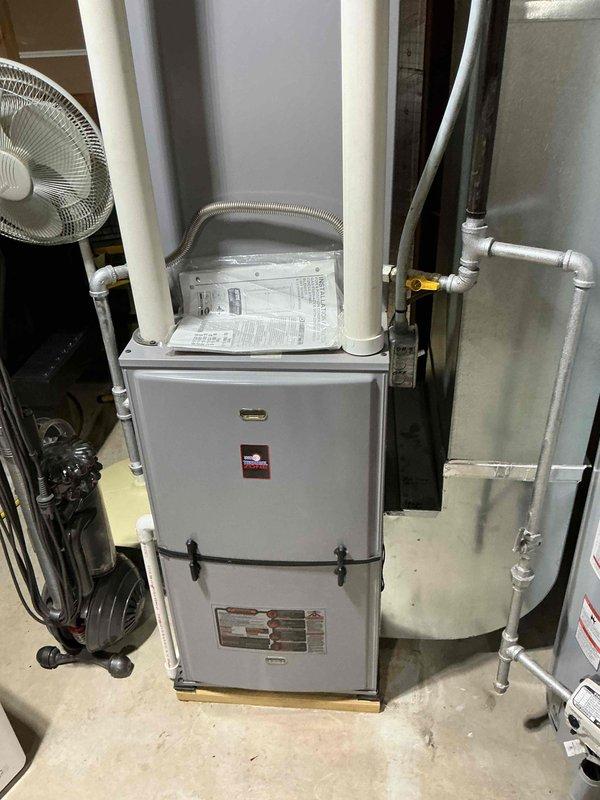 Completed comprehensive air conditioning tune-up and maintenance service as part of family rewards plan agreement. Cleaned routine components, flushed condensate drain line, and performed full system testing to verify proper operation. Documented equipment condition with photographs of AC unit and furnace for service records.