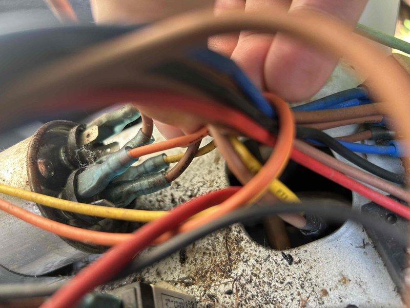 Responded to no cooling call on 10+ year old Energy Knight mini split system. Upon arrival, found indoor unit operating but outdoor condenser unit not running. Inspection revealed mouse nest inside outdoor unit with numerous loose electrical connections. Removed rodent nesting material, cleaned affected areas, and tightened all loose wire connections at terminal block. Tested system operation and confirmed outdoor unit now running properly with normal cycling.