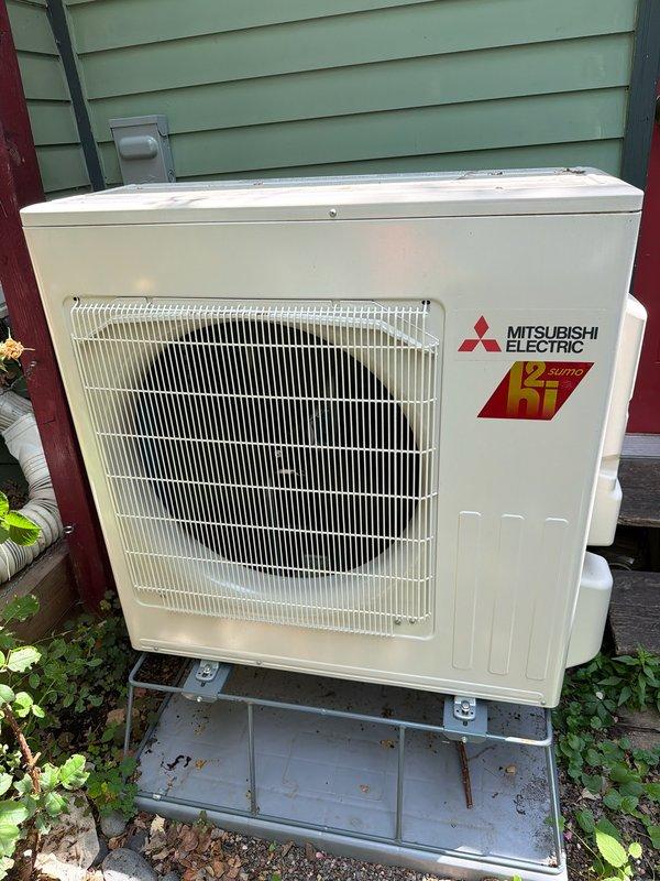 Responded to service call for Mitsubishi Electric mini-split system in garage with inadequate cooling performance. Upon inspection, discovered system was completely flat on refrigerant charge. Recharged system to manufacturer specifications under warranty coverage. Verified proper cooling operation of both indoor wall-mounted evaporator unit and outdoor condenser unit before completing service.