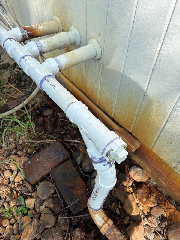 Responded to a sump pump discharge pipe leak on the exterior of the residence. Upon inspection, discovered that the discharge pipes for three sump pumps were not properly glued together, causing water leakage at the connections. After discussing repair options with the homeowner, including the use of no-hub couplings for seasonal removal, the decision was made to permanently glue all fittings together while maintaining removable cleanout caps for future access. Refluxed all pipe fittings and connections to ensure proper adhesion. Activated each sump pump individually and monitored multiple discharge cycles to verify all repairs were watertight with no leaks present at any connection points. Work area was cleaned and system left in full operational service.