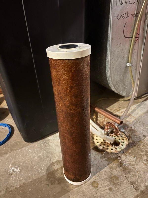 Responded to low water pressure complaint affecting entire home, particularly during morning hours. Upon inspection and consultation, determined that a severely clogged whole home water filter was restricting flow throughout the plumbing system. The pressure issue was most noticeable in the mornings when the outdoor sprinkler system was operating simultaneously, creating compound demand on the already-restricted water supply.

Removed and inspected the filter cartridge, which showed heavy sediment accumulation and discoloration throughout the filter media, confirming significant blockage. Created parts order for replacement filter cartridge and placed existing filter system in bypass mode to restore immediate water pressure to the home while awaiting the new cartridge. Documented filter condition with photographs showing the extent of sediment buildup on the cylindrical cartridge. Replacement filter installation will be scheduled upon parts arrival to restore full filtration capacity t