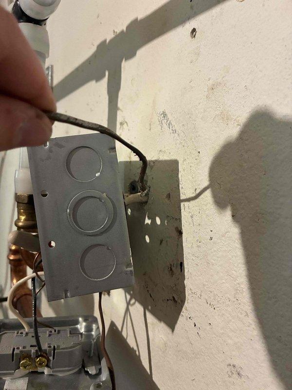 Responded to service call for in-floor hydronic heating system running continuously despite thermostat being in the off position. Performed systematic diagnostic testing by disconnecting thermostat wiring at multiple points to isolate the fault. Determined that thermostat wire is shorted between the mechanical room splice point and the wall-mounted thermostat location. Disconnected and left thermostat wires unattached at the junction box in the mechanical room to prevent boiler from continuous operation while maintaining domestic hot water functionality. Coordinated with electrical contractor to run new thermostat wire from mechanical room to thermostat location, scheduled for completion within two days.