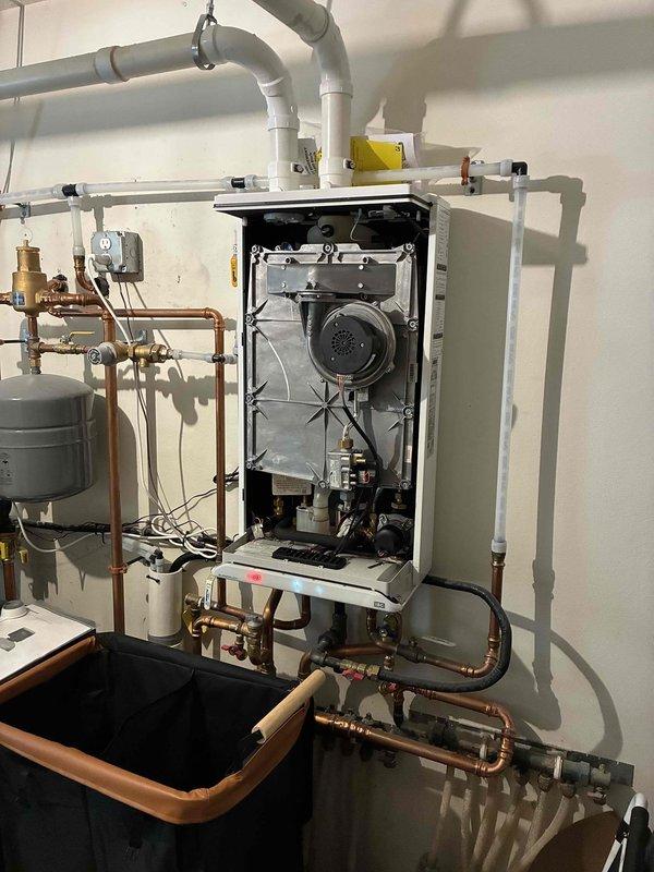 Responded to service call for in-floor hydronic heating system running continuously despite thermostat being in the off position. Performed systematic diagnostic testing by disconnecting thermostat wiring at multiple points to isolate the fault. Determined that thermostat wire is shorted between the mechanical room splice point and the wall-mounted thermostat location. Disconnected and left thermostat wires unattached at the junction box in the mechanical room to prevent boiler from continuous operation while maintaining domestic hot water functionality. Coordinated with electrical contractor to run new thermostat wire from mechanical room to thermostat location, scheduled for completion within two days.