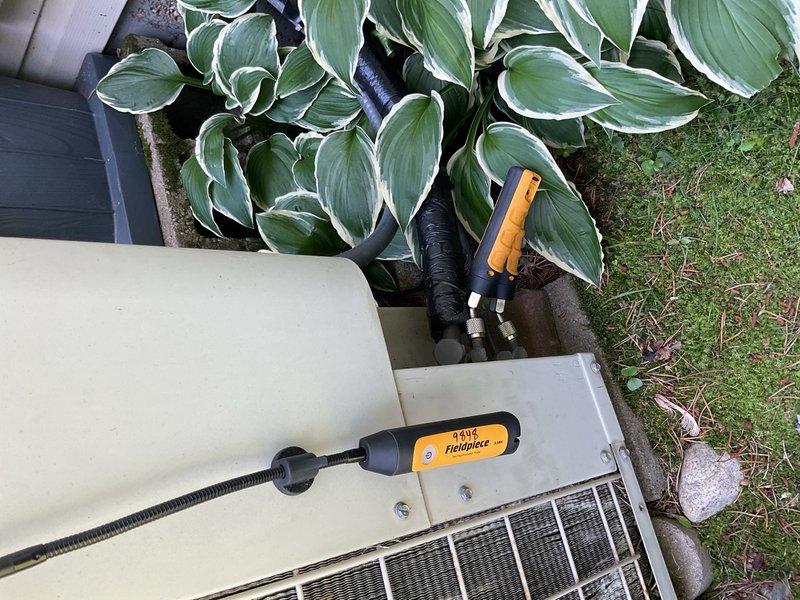 Responded to a no cooling complaint on a 25-year-old residential air conditioning system. Upon arrival, found the indoor evaporator coil partially frozen and confirmed the system was low on R-22 refrigerant. Performed diagnostic testing which revealed inadequate cooling capacity with only a 9°F temperature split across the coil, well below the normal 15-20°F range expected for proper operation. The indoor furnace unit showed significant age-related deterioration with visible rust on copper refrigerant lines and connection points. The outdoor condensing unit was evaluated with digital manifold gauges to verify refrigerant charge and system pressures. Given the system's age (manufactured in 1995), use of obsolete R-22 refrigerant, declining performance, and overall condition of the equipment, recommended system replacement rather than repair. Coordinated with sales team to schedule equipment replacement consultation with homeowner to discuss modern, efficient replacement options.