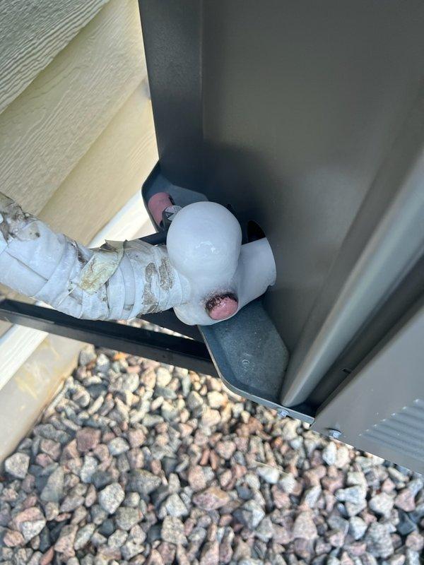 Responded to no cooling complaint with ice formation on refrigerant lines of 8-year-old air conditioning system. Performed comprehensive diagnostic inspection of thermostat, indoor unit components including filter, drain pan, blower motor, and evaporator coil, confirming no freeze condition present at time of service. Inspected outdoor unit including condenser coil, compressor, contactor, and run capacitor with all components functioning within normal parameters. Verified refrigerant charge and measured temperature split across evaporator coil, both within acceptable range. Identified failed blower motor capacitor reading below manufacturer specifications as root cause of reduced airflow leading to coil icing. Replaced defective blower motor capacitor with OEM equivalent part. Cycled system through complete cooling operation, verified proper airflow restoration and normal operating temperatures. System restored to full cooling capacity with instructions provided to monitor performance 