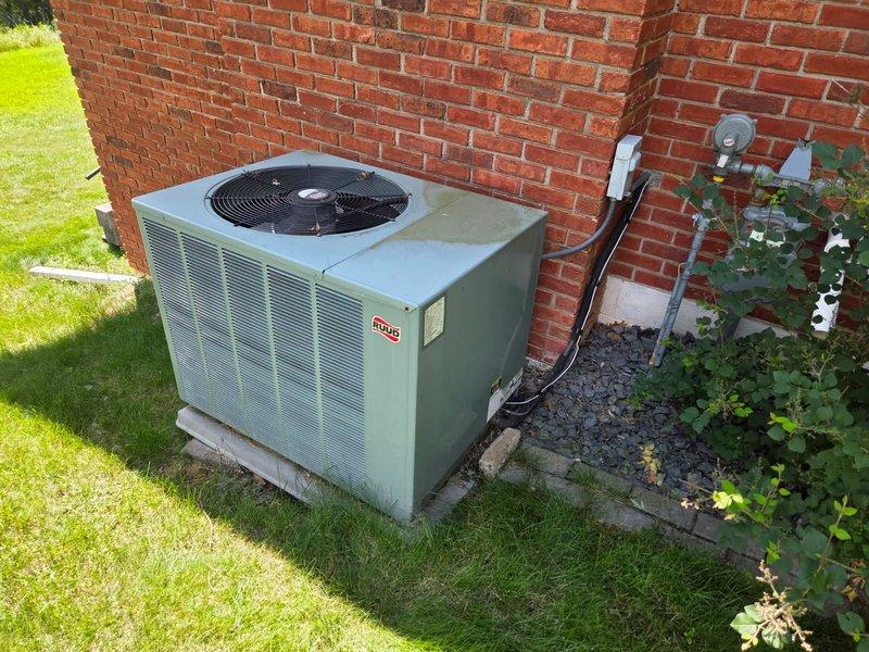 Responded to no cooling complaint on 17-year-old Ruud air conditioning system. Diagnosed and found failed run capacitor and low refrigerant charge preventing proper system operation. Replaced defective capacitor and added refrigerant to restore cooling function, providing temporary solution to get unit through remainder of cooling season.