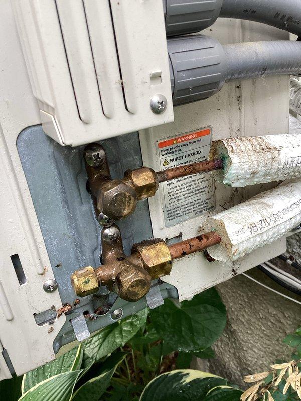 Responded to no cooling call on mini split system. Upon arrival, unit was blowing warm air from indoor head unit. Performed system diagnostics and discovered low refrigerant charge. Inspected outdoor unit connections and observed aged brass fittings with corrosion and patina buildup on refrigerant lines, indicating potential leak points. Indoor evaporator coil showed dust accumulation but no visible damage. Confirmed system was operating with insufficient refrigerant levels causing loss of cooling capacity. Discussed repair options with customer including leak detection, repair of refrigerant leak, system recharge, and potential replacement considerations given age and condition of equipment.