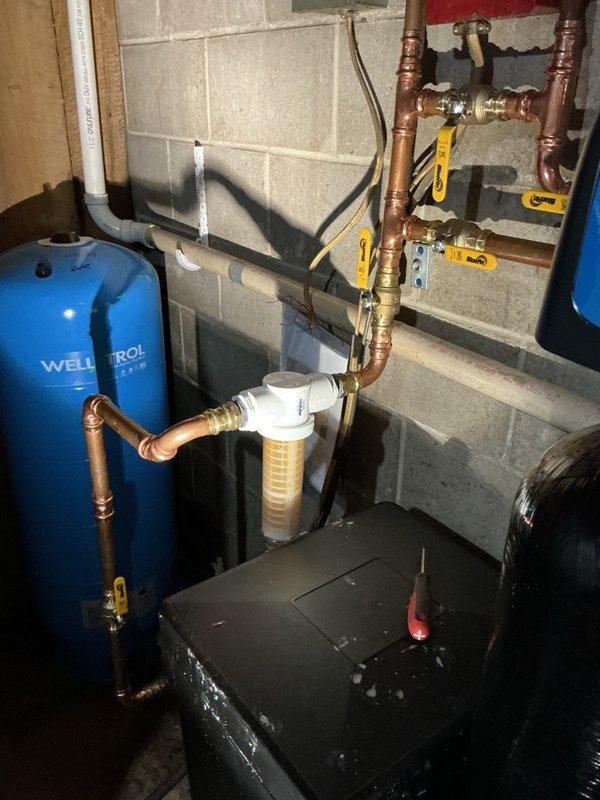 Responded to service call for assistance with Rusco spin-down sediment filter maintenance on residential well water system. Upon arrival, determined homeowner had been rotating filter housing in incorrect direction, resulting in overtightening rather than removal. Successfully loosened filter housing and demonstrated proper removal technique and rotation direction for future maintenance. Removed and inspected internal stainless steel screen element, showing homeowner correct cleaning procedure for sediment removal. Filter housing and screen were in good condition with no damage from overtightening. Reassembled unit properly and verified system operation with no leaks. Provided instruction on routine maintenance intervals and proper disassembly/reassembly procedures to ensure homeowner can independently perform future filter cleaning.