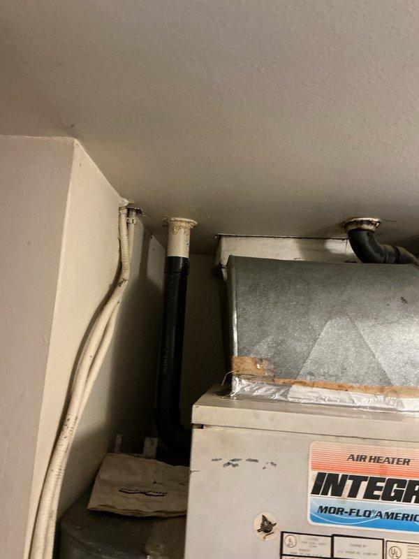 Responded to no hot water call on electric American Polaris water heater system with integrated air coil assembly. Upon inspection, discovered significant leaking from the air coil unit mounted on top of the water heater, with visible moisture and condensation present on connected piping. Confirmed complete loss of hot water functionality. Documented system configuration including all plumbing connections, ductwork, and air handler components. Awaiting property management authorization and confirmation of replacement unit availability on-site before proceeding with repair or replacement recommendations.