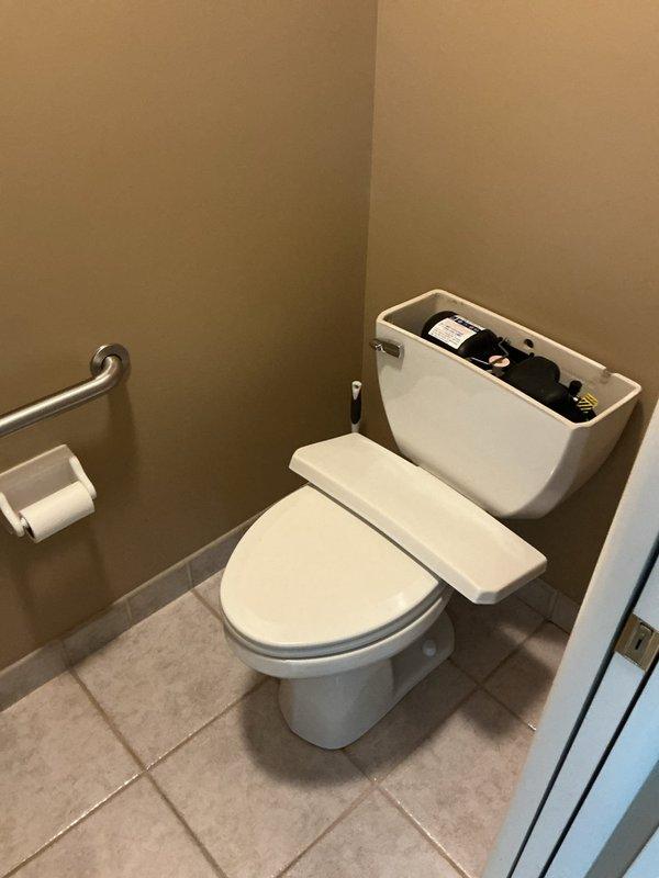 Responded to service call for continuously running ADA-compliant toilet. Upon inspection, determined that aging internal tank components and deteriorated shut-off valve required replacement to restore proper function. Removed tank lid to assess fill valve and flush mechanism, confirming mechanical failure causing constant water flow. Successfully replaced faulty components and shut-off valve, restoring toilet to full operational status.