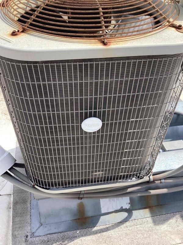 Completed preventive maintenance tune-up on rooftop Payne air conditioning unit containing R22 refrigerant. Performed comprehensive system inspection with diagnostic testing revealing elevated temperature readings and potential refrigerant charge concerns. Unit currently operational but showing signs of age including exterior corrosion on mounting platform and weathering on condenser components, with customer planning future replacement and declining quote at this time.