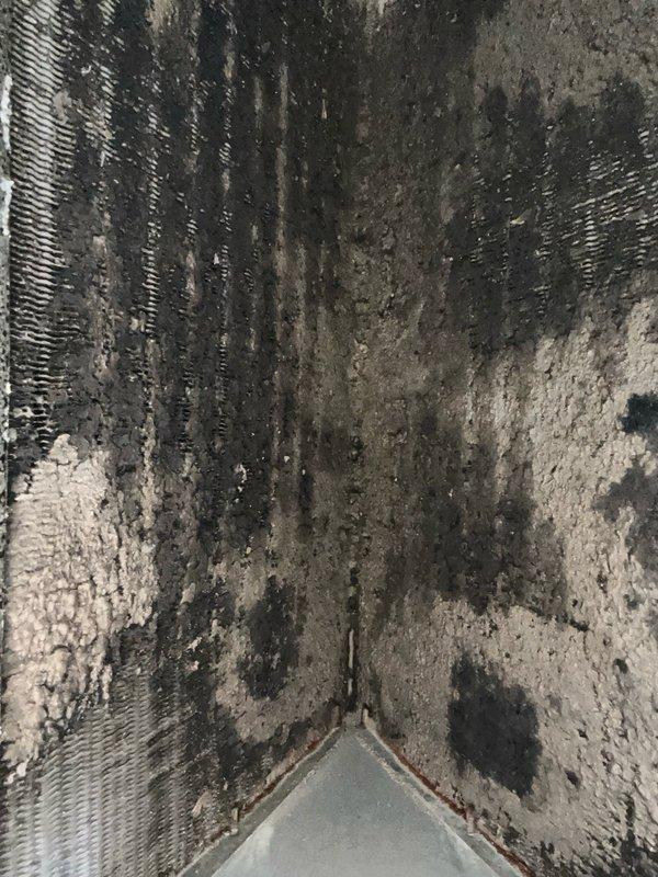 Performed evaporator coil cleaning on residential air conditioning system. Upon arrival, found heavy accumulation of dust, debris, and biological growth throughout the coil assembly, significantly restricting airflow. Manually brushed substantial debris from the bottom side of the coil fins and flushed thoroughly with water until drainage ran clear. Additionally, installed sheet metal patch to repair hole in ductwork. After cleaning, tested system operation and confirmed significantly improved airflow and proper drainage, restoring unit to optimal performance.