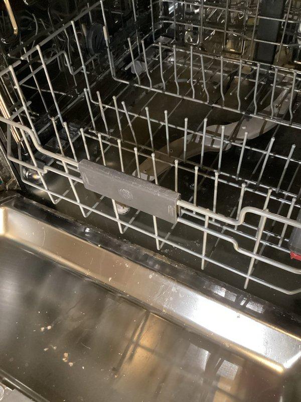 Responded to water leak emergency with mitigation crew already on-site. Diagnosed dishwasher as the source of active water leak affecting kitchen flooring. Upon inspection, found dishwasher pump had failed, causing water to discharge onto floor rather than drain properly. Unit exhibited heavy accumulation of lint and debris on exterior components and housing, indicating age and lack of maintenance. Verified internal components showed water pooling in bottom basin with compromised drainage system. Pulled appliance from cabinet opening to fully assess leak source and extent of damage. Confirmed pump assembly failure as primary cause of water intrusion. Documented conditions with photographic evidence for insurance claim purposes. Recommended complete dishwasher replacement due to pump failure and overall deteriorated condition of unit.