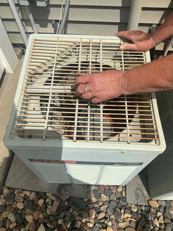 Responded to no cooling complaint on a 20+ year old Trane air conditioning system that had been inoperative for several weeks. Upon inspection, diagnosed a seized condenser fan motor preventing proper heat rejection from the outdoor unit. Replaced the failed condenser fan motor to restore system operation and scheduled comfort advisor consultation to discuss equipment replacement options given the age and condition of the unit.
