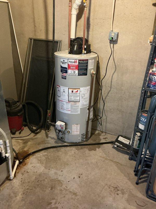 Replaced a 20-year-old leaking 50-gallon natural gas water heater with a new Bradford White 10-year warranty power vent unit. Installation included all necessary parts, copper piping connections, electrical wiring, venting components, proper permitting, and disposal of the old unit. The new power vent water heater was installed in the basement utility area and tested for proper operation.