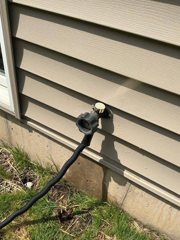Responded to outdoor faucet leaking when water was turned on. Upon inspection, found the gasket on the vacuum breaker had completely disintegrated. Replaced the vacuum breaker assembly and restored water service. Observed a minor residual leak and tested system pressure, which measured 95 psi—significantly above the recommended residential range of 40-60 psi. Recommended installation of a pressure reducing valve to prevent premature wear on plumbing fixtures and components. Customer declined the pressure reduction service at this time. Advised that the elevated water pressure may cause the new vacuum breaker to develop leaks prematurely.