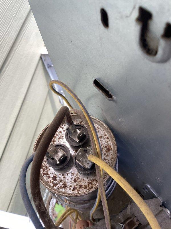 Responded to no cooling complaint on residential air conditioning system over 10 years old. Upon arrival, confirmed outdoor unit was not operating. Diagnostic testing revealed failed dual run capacitor with visible corrosion and deterioration. Further inspection identified condenser fan motor with failing bearings and reduced performance. Replaced defective capacitor and condenser fan motor. Verified proper electrical connections, tested system operation, and confirmed unit cooling normally with correct voltage readings at contactor.