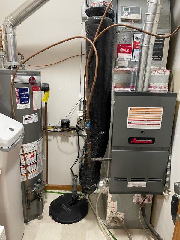 Responded to customer concern regarding brown spots and condensation appearing on furnace room ceiling. Conducted thorough diagnostic inspection of HVAC system including downflow furnace, return air ducts, refrigerant lines, venting, and fresh air return to identify potential moisture sources. Inspected return duct pathways and confirmed no signs of condensation or water accumulation within ductwork. Verified refrigerant line routing does not pass through affected ceiling areas. Confirmed downflow furnace configuration eliminates cold supply ducts as potential condensation source. Determined water damage and ceiling discoloration is not HVAC-related based on equipment location, duct routing, and absence of moisture in system components. Documented findings with photographic evidence showing water staining patterns on ceiling and confirmed HVAC equipment condition. Recommended plumbing department investigation with exploratory ceiling access to identify actual water source above damaged