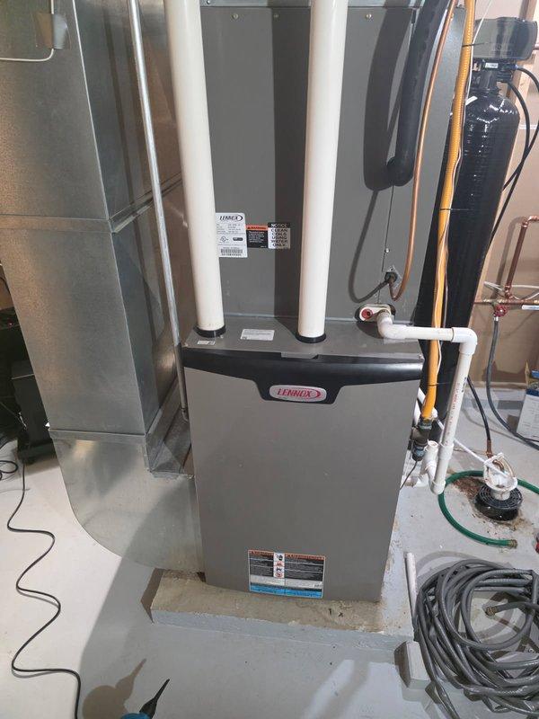 Responded to cooling performance issues on a 5-year-old Lennox AC system that was unable to maintain temperature when outdoor temperatures exceeded 80°F. Upon arrival, verified system operation and confirmed air filter was clean and blower functioning properly. Performed condenser coil cleaning on outdoor unit to improve heat transfer efficiency. Connected manifold gauges to check refrigerant charge levels and identified system was low on refrigerant. Discussed repair options with homeowner, who approved refrigerant recharge with fluorescent dye injection for future leak detection. Recharged system to manufacturer specifications and injected UV dye into refrigerant circuit. During gauge removal, discovered leaking Schrader valve core that would not seal properly. Replaced faulty valve core to stop refrigerant loss. System restored to proper cooling capacity, though additional leak sources may exist and should be monitored. Recommend follow-up inspection with UV light to identify any ot