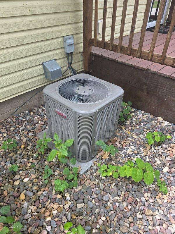 Responded to cooling performance issues on a 5-year-old Lennox AC system that was unable to maintain temperature when outdoor temperatures exceeded 80°F. Upon arrival, verified system operation and confirmed air filter was clean and blower functioning properly. Performed condenser coil cleaning on outdoor unit to improve heat transfer efficiency. Connected manifold gauges to check refrigerant charge levels and identified system was low on refrigerant. Discussed repair options with homeowner, who approved refrigerant recharge with fluorescent dye injection for future leak detection. Recharged system to manufacturer specifications and injected UV dye into refrigerant circuit. During gauge removal, discovered leaking Schrader valve core that would not seal properly. Replaced faulty valve core to stop refrigerant loss. System restored to proper cooling capacity, though additional leak sources may exist and should be monitored. Recommend follow-up inspection with UV light to identify any ot