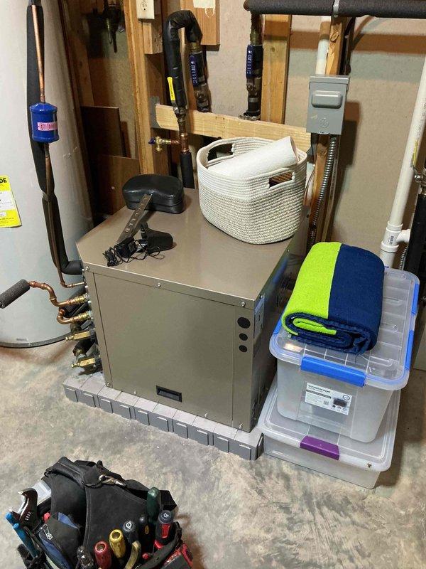 Responded to water leak originating from HVAC system. Inspected evaporator drain pan and discovered obstruction caused by wood chips and carpet fibers blocking drainage path, resulting in water backup and overflow. Removed debris from drain pan and thoroughly flushed system with water to clear remaining particulate matter from drain line. Verified proper drainage function and tested air conditioning operation, confirming 20° temperature split across evaporator coil. System restored to normal operation with no active leaks present.