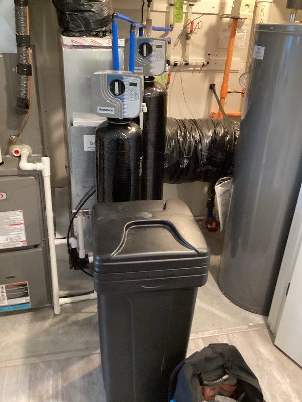 Completed water heater flush with no issues identified. Inspected water treatment system including dual filtration tanks and water softener unit, all equipment found to be in good working condition. Plumbing system is relatively new with proper installation observed throughout mechanical room.