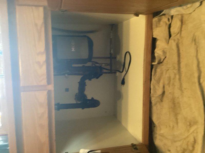 Responded to clogged kitchen sink with water backup that had sprayed beneath the cabinet. Removed existing plug-in garbage disposal unit per homeowner request, as dishwasher drain line was independently plumbed. Snaked kitchen drain line to clear obstruction and restore proper drainage. Installed standard sink basket strainer assembly to replace disposal opening, ensuring proper seal and functionality. Tested drainage flow and verified no leaks at connections. Left work area clean with sink fully operational.