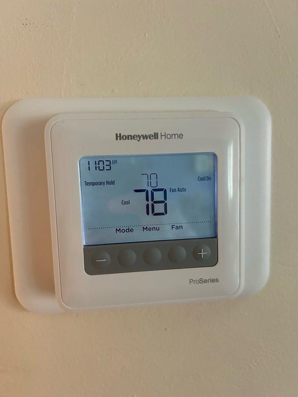 Performed comprehensive AC maintenance inspection on rooftop unit after obtaining roof access from front desk. Verified thermostat operation showing proper cooling mode and temperature control, confirmed recent filter change was adequate, and inspected blower assembly. Evaluated outdoor coil condition, tested electrical components including contactor and capacitor with clamp meter showing normal amperage readings, checked condensate drain flow, and measured refrigerant performance with temperature split within manufacturer specifications. All system components operating properly with no mechanical defects or safety concerns identified at time of service.