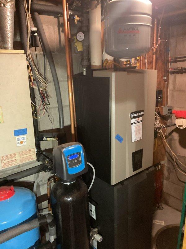 Completed follow-up service call to address previous water discharge from relief valve. Replaced auto fill valve and backflow preventer to correct system over-pressurization issue. Refilled hydronic system, purged air by leaving automatic vent open on expansion tank, and tested all heating zones for proper operation. Installed auto filter for boiler and new pressure relief valve. All zones operated as designed with no active leaks observed at time of service.
