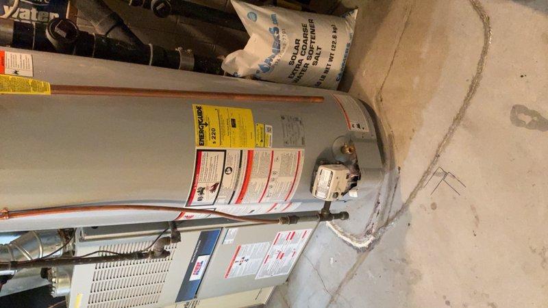Responded to service call for leaking 40-gallon natural gas water heater with standard vent configuration. Upon inspection, confirmed active leak that worsens significantly during high hot water demand periods. Unit remains operational but requires replacement to prevent potential water damage and ensure reliable hot water delivery. Documented existing installation including copper supply lines, pressure relief valve configuration, and venting system. Provided estimate for complete water heater replacement with new 40-gallon natural gas unit and standard atmospheric venting.
