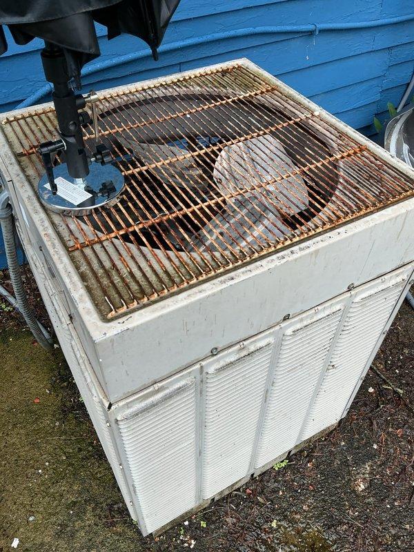 # HVAC Service Completed

Responded to no cooling call on 40-year-old residential air conditioning system. Upon arrival, confirmed unit would not start. Performed comprehensive diagnostic evaluation of outdoor condenser unit, which showed significant age-related deterioration including extensive rust on fan grille and overall weathering of cabinet.

Testing revealed failed contactor preventing system startup. Used digital multimeter to measure run capacitor, which tested at 24.17 microfarads, significantly below manufacturer specifications, confirming capacitor failure. Visual inspection identified failing condenser fan motor showing signs of wear and reduced operational capacity.

Given the system's age at 40 years—well beyond typical 15-20 year equipment lifespan—and multiple simultaneous component failures, advised customer that repair costs would be substantial with limited long-term reliability. Discussed that even with component replacement, additional failures are likely imminen