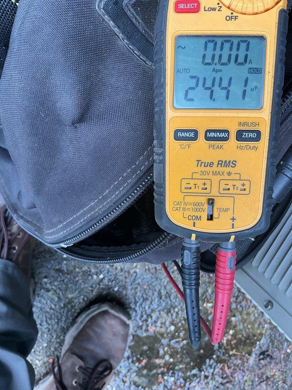 # HVAC Service Completed

Responded to no cooling call on 40-year-old residential air conditioning system. Upon arrival, confirmed unit would not start. Performed comprehensive diagnostic evaluation of outdoor condenser unit, which showed significant age-related deterioration including extensive rust on fan grille and overall weathering of cabinet.

Testing revealed failed contactor preventing system startup. Used digital multimeter to measure run capacitor, which tested at 24.17 microfarads, significantly below manufacturer specifications, confirming capacitor failure. Visual inspection identified failing condenser fan motor showing signs of wear and reduced operational capacity.

Given the system's age at 40 years—well beyond typical 15-20 year equipment lifespan—and multiple simultaneous component failures, advised customer that repair costs would be substantial with limited long-term reliability. Discussed that even with component replacement, additional failures are likely imminen