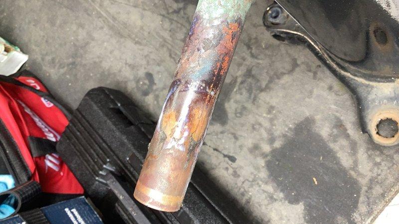 Responded to callback for newly installed HVAC unit experiencing water leakage. Upon inspection, identified failed condensate drain line with severe corrosion and oxidation throughout the copper piping. Replaced defective condensate line and verified proper drainage function, resolving the leak issue.