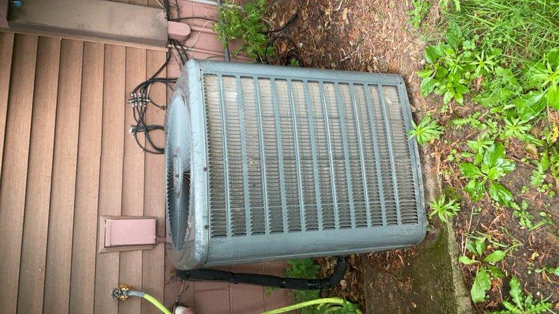 Responded to no-cool complaint on 14-year-old residential air conditioning system running constantly and unable to maintain temperature setpoint. Upon inspection, identified severely restricted airflow due to heavily soiled furnace filter and dirty outdoor condenser coil causing poor heat rejection. Cleaned condenser coil thoroughly to restore proper airflow and heat transfer capability. Replaced furnace filter with customer-supplied unit. Post-service testing revealed system achieving 18–19°F temperature split across evaporator coil, indicating satisfactory cooling performance restoration. Refrigerant charge assessment inconclusive due to inclement weather conditions during testing; recommended recheck during dry, stable ambient conditions before making any refrigerant adjustments. Documented findings with photos and communicated results to homeowner with recommendations for increased filter maintenance frequency and basement dehumidification to reduce system runtime.