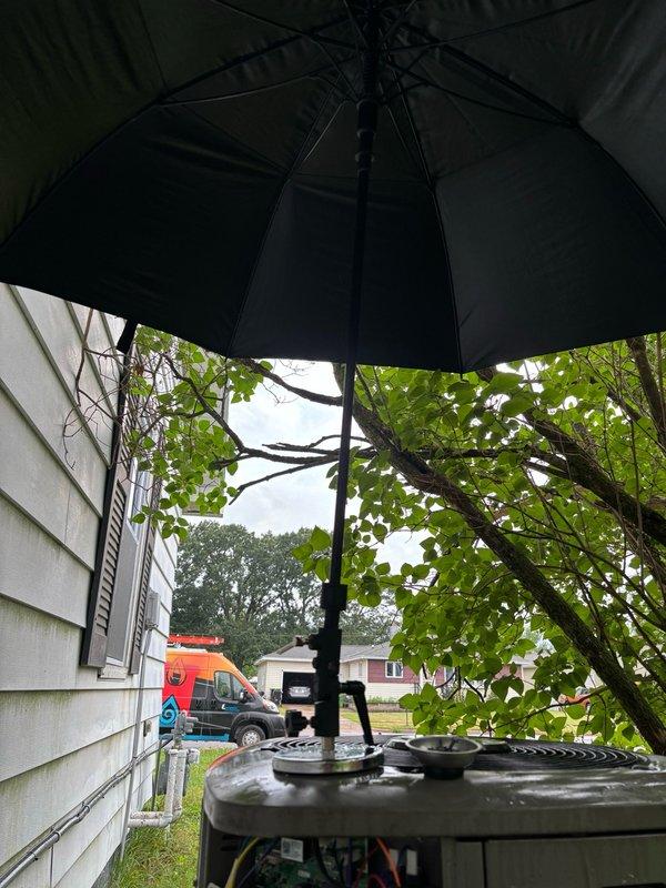 Responded to no-cool complaint on 4-year-old residential air conditioning system. Upon arrival, found outdoor condenser unit heavily obstructed by overgrown vegetation and debris accumulation, preventing proper airflow and heat rejection. Condenser coil was completely blocked, causing system shutdown and loss of cooling capacity.

Cleared vegetation from around unit perimeter to restore proper clearance. Performed thorough condenser coil cleaning using pressure washing to remove packed debris and restore heat transfer efficiency. Replaced dirty air filter with homeowner-supplied filter. Restarted system and conducted operational testing. Verified proper cooling function with 22°F temperature split across evaporator coil, confirming system returned to normal operation. Recommended maintaining adequate clearance around outdoor unit to prevent future airflow restrictions.