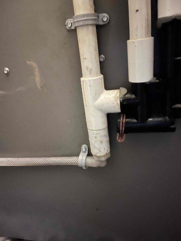 Replaced the evaporator coil assembly with integrated drain pan on a 2-year-old Lennox vertical furnace unit under full warranty due to drain pan leakage. Disconnected and removed the failed evaporator coil, installed the new replacement unit, evacuated the refrigerant system to proper vacuum specifications, and recharged the system to manufacturer specifications. Verified proper system operation with a 23-degree temperature split across the coil and confirmed the drain pan is functioning correctly without leakage.
