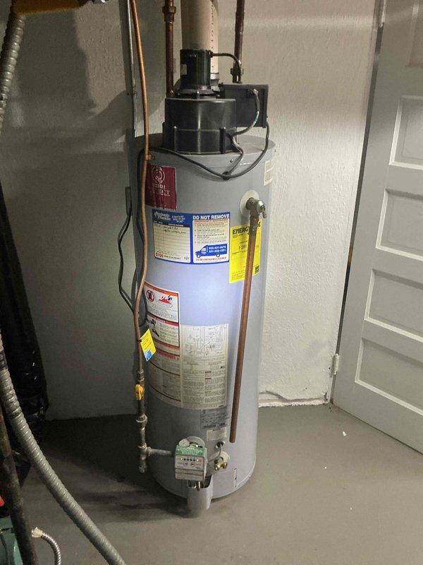 Responded to service call for non-operational tanked water heater installed in 2009. Performed on-site diagnostic assessment and provided second opinion following previous replacement estimate. Upon inspection, confirmed water heater failure with no viable repair options due to age and condition of unit. Discussed replacement specifications and options with customer, documenting existing installation configuration including copper supply lines, gas control valve assembly, and venting system. Photographed current installation for replacement planning purposes.