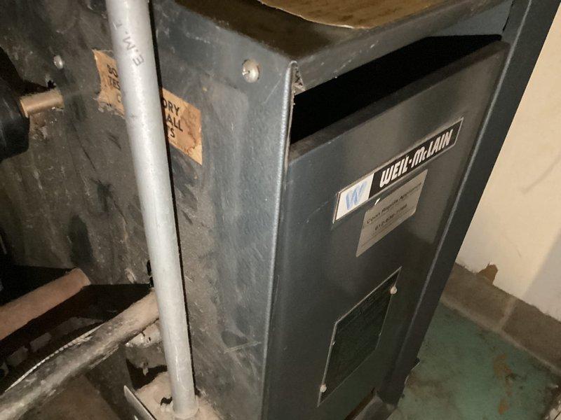 Completed air conditioning tune-up and maintenance on Guardian outdoor unit. Inspected system components, identified low refrigerant levels, and documented equipment condition with photos of both the outdoor condensing unit and associated indoor Weil-McLain furnace system.