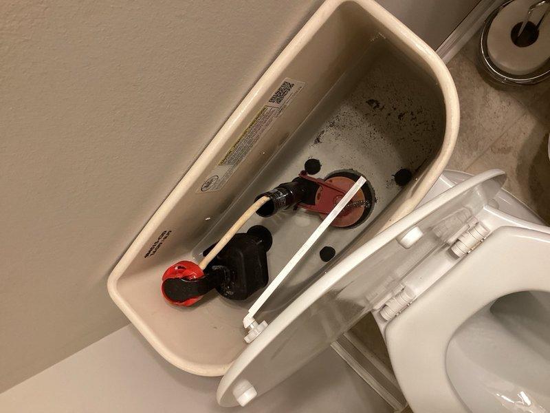 Responded to service call for garbage disposal replacement. Upon inspection, determined that the garbage disposal unit was jammed rather than requiring full replacement, successfully cleared the jam and restored unit to proper working operation. Examined toilet as requested and discovered toy motorcycle lodged inside tank, which was removed. Assessed bathroom plumbing fixtures and provided estimate for replacement of worn shutoff valves under sink to prevent potential future leaks.