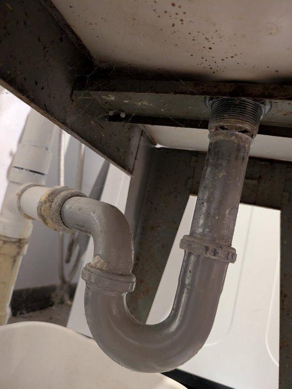 Responded to a drain leak at the laundry tub caused by severe corrosion of the P-trap assembly. Removed and replaced the deteriorated P-trap, including new slip-joint nuts and washers at both the tailpiece and wall stub-out connections. Upon inspection, found extensive corrosion and grime buildup on the existing trap that had compromised the seal integrity. Installed new P-trap assembly, ensuring proper alignment and secure connections at all joints. Tested the drain system for leaks and confirmed proper drainage flow upon completion.