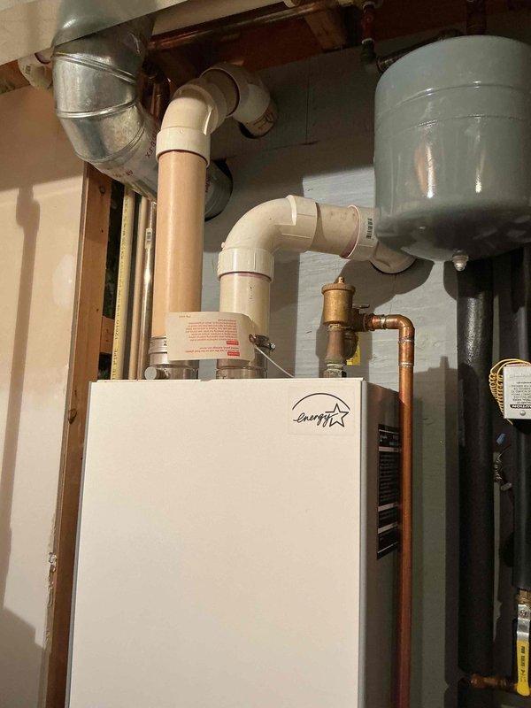 Responded to service call for 17+ year old gas boiler with suspected thermostatic balance valve failure. Upon inspection, confirmed severe corrosion and mineral buildup on Bell & Gossett mixing valve and associated components, including heavily corroded Taco 007 circulator pump. Isolated the boiler system, drained affected zone, and successfully removed and replaced the deteriorated thermostatic mixing valve. Reinstalled connections, refilled system, purged air from lines, and verified proper operation and temperature control. System restored to normal operation with improved mixing valve function.