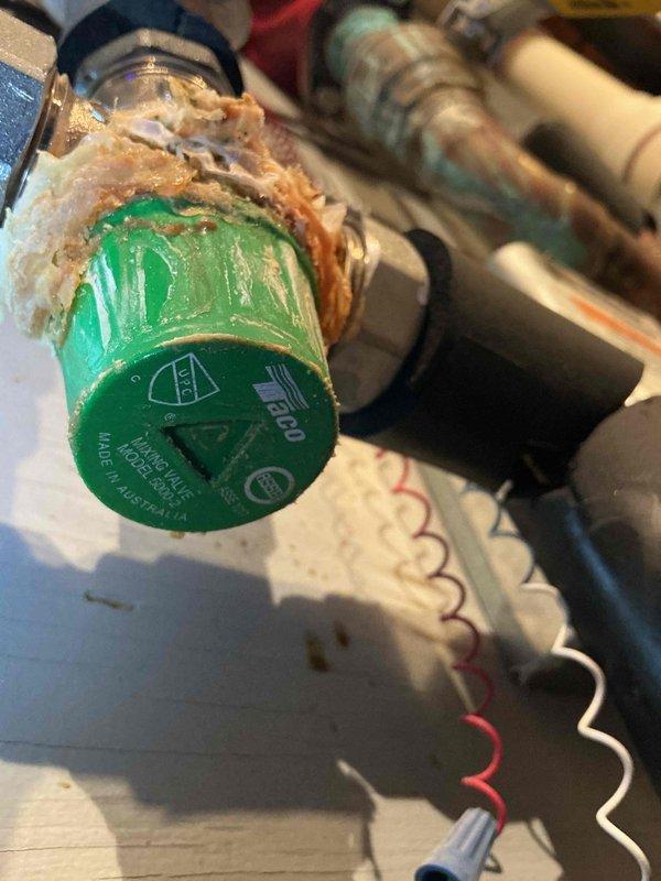 Responded to service call for 17+ year old gas boiler with suspected thermostatic balance valve failure. Upon inspection, confirmed severe corrosion and mineral buildup on Bell & Gossett mixing valve and associated components, including heavily corroded Taco 007 circulator pump. Isolated the boiler system, drained affected zone, and successfully removed and replaced the deteriorated thermostatic mixing valve. Reinstalled connections, refilled system, purged air from lines, and verified proper operation and temperature control. System restored to normal operation with improved mixing valve function.