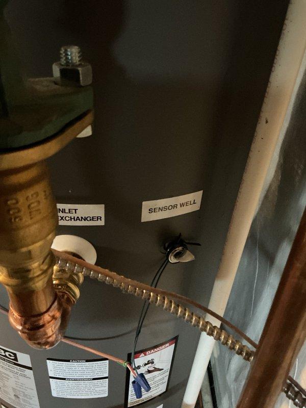 Replaced IBC indirect water heater tank under manufacturer parts warranty, including complete removal and disposal of failed unit. During system restoration, the backflow preventer began leaking upon water supply activation, requiring immediate replacement with new brass backflow prevention device. Installed new indirect water heater with expansion tank, connected all copper piping, and verified proper integration with existing IBC boiler system. Purged air from hydronic heating system, tested all heating zones for proper operation, and confirmed system pressure stabilized at 22 PSI. All components functioning within normal parameters upon completion.