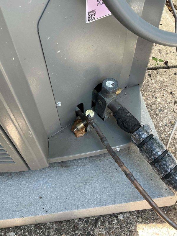Completed annual air conditioning maintenance and inspection on outdoor condensing unit. Found condenser coil heavily plugged with dirt and debris, restricting airflow and reducing system efficiency. Performed thorough solvent cleaning of condenser coil to restore proper heat transfer capability. Installed locking refrigerant line caps on service ports to prevent tampering and refrigerant loss. Inspected all electrical connections, refrigerant lines, and plumbing components for proper operation and secure mounting. Unit returned to normal operating condition with improved airflow through condenser coil.