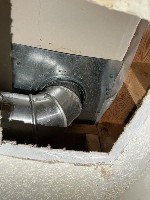 Responded to water leak investigation in mechanical room ceiling. Previous HVAC contractor had determined leak was not originating from furnace system. Upon arrival, performed visual inspection of affected ceiling area and accessed ceiling cavity to diagnose water source. Cut access opening in drywall to expose plumbing lines and HVAC ductwork above mechanical room. Thoroughly inspected all visible plumbing connections, supply lines, and drain lines within the ceiling cavity. Examined galvanized HVAC ductwork and transitions for signs of condensation or moisture accumulation. Confirmed that plumbing system was not the source of the water leak. Documented conditions with photographs showing ductwork installation, wooden framing, and ceiling cavity components for further investigation by appropriate trade contractor.